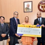 लारसेन एंड टूब्रो ने योगी को चेक सौंपा