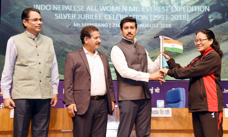col. rajyavardhan singh rathore handing over the flags to bimla negi